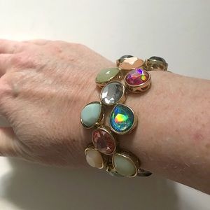 Multi color gem bracelet encased in gold tone